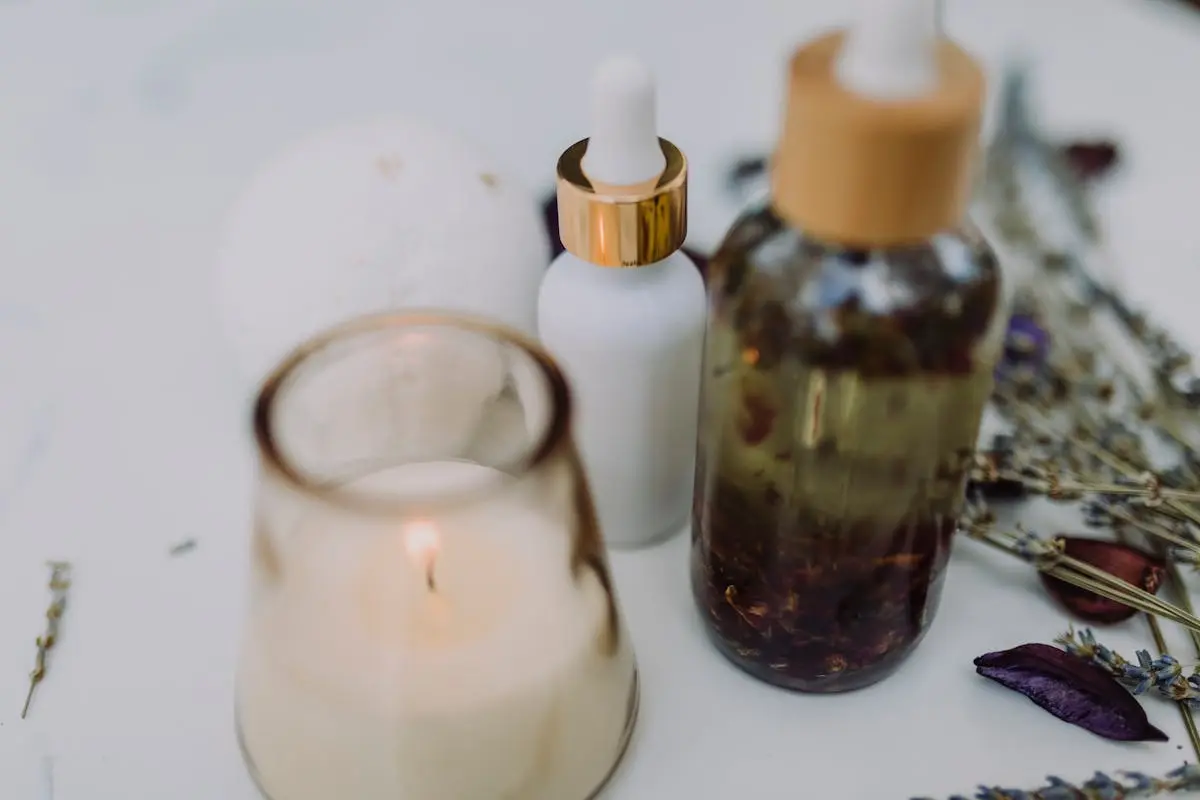 An elegant display featuring candles, aromatic oils, and lavender blooms